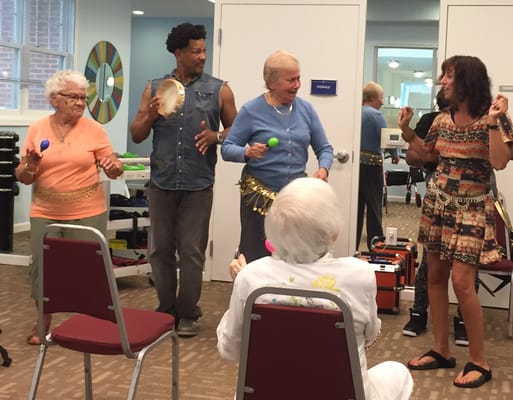 Residents and staff engaging in a music activity