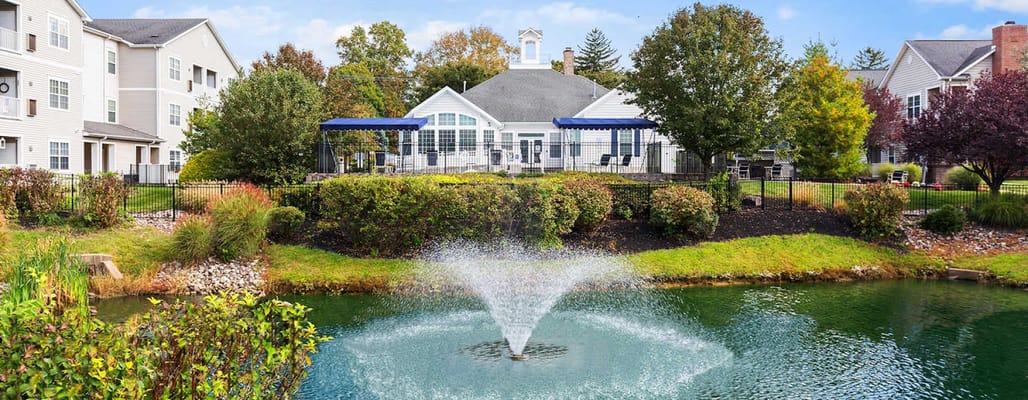 Scenic view of outdoor space with fountain and building