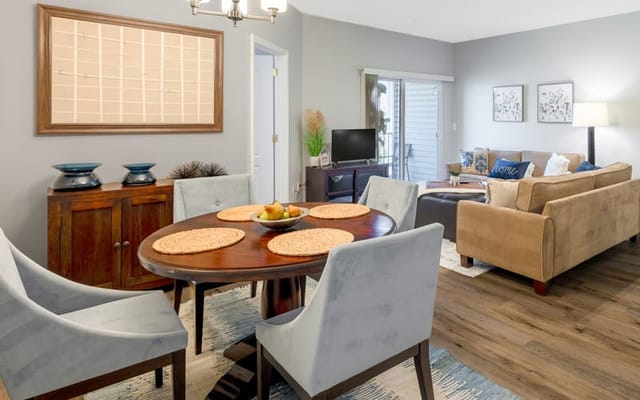 Bright common area with seating and a dining table