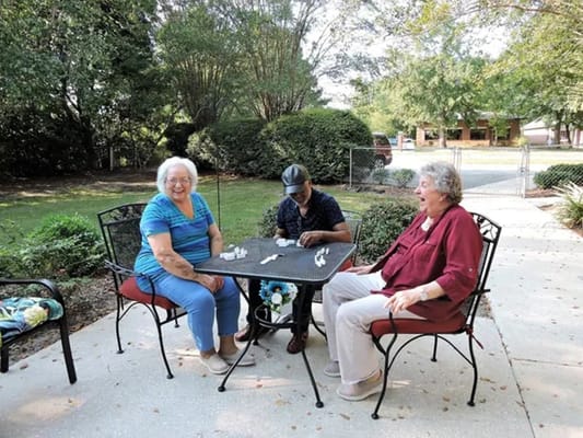 Residents enjoying time together outdoors at a table