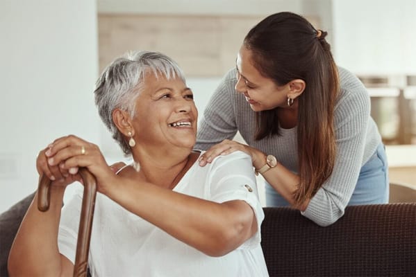 A caregiver interacting with a senior resident indoors