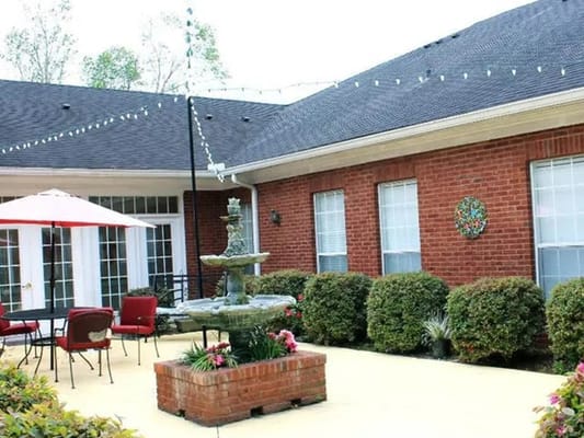 Outdoor patio area with seating and a fountain