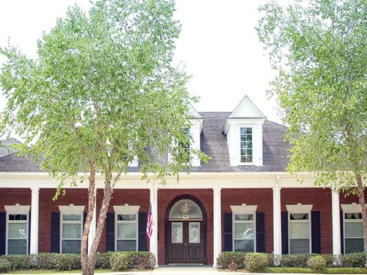 Exterior view of a senior living facility with trees