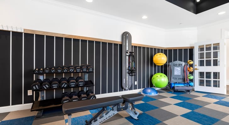 Interior fitness area with weights and exercise equipment