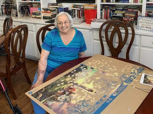 Resident working on a puzzle in an activity area