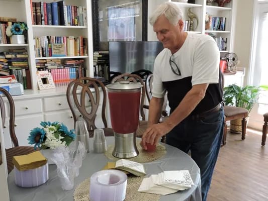 A resident preparing drinks in a common area