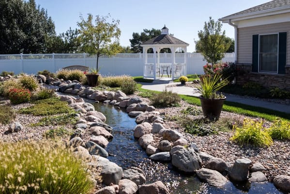 Beautifully landscaped garden with gazebo and stream