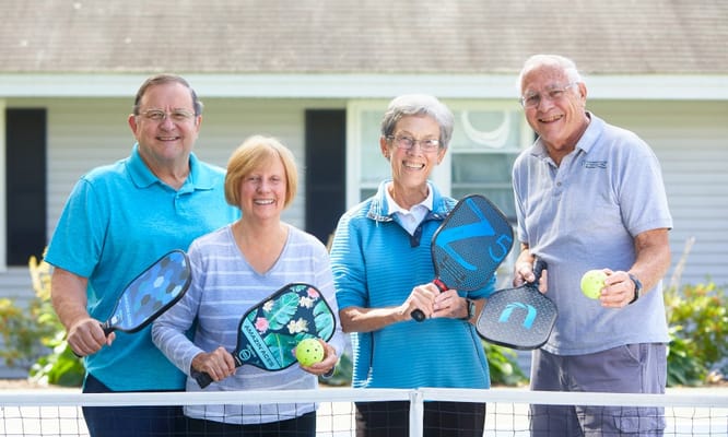 Residents enjoying outdoor pickleball activity