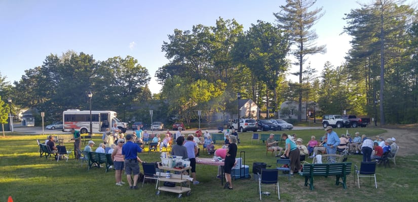 Residents enjoying an outdoor gathering with chairs and food
