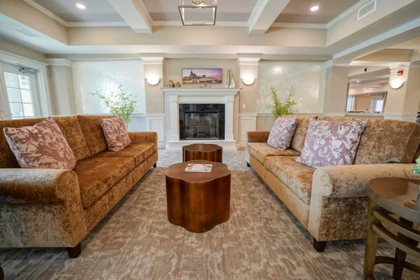 Cozy common area with plush sofas and fireplace
