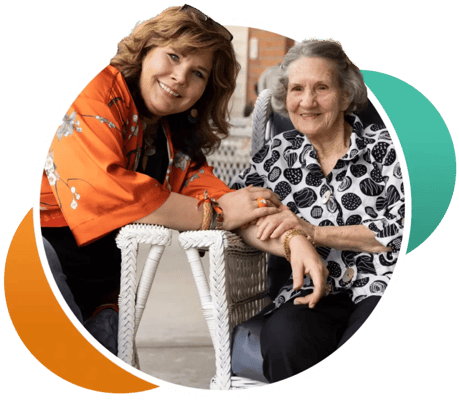 A staff member and resident smiling together in a relaxed setting