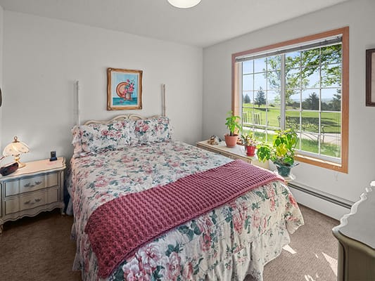 Cozy bedroom with floral bedding and a sunny window