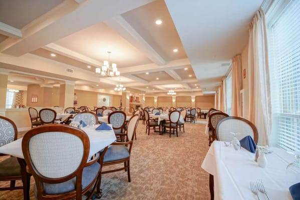 Dining area with neatly set tables and chairs