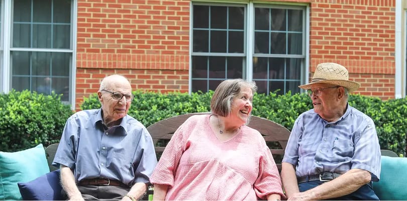 Three residents enjoying time together outdoors