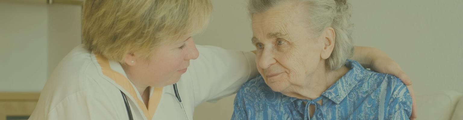 Healthcare worker interacting with a senior resident