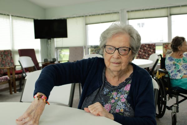 Resident in a common area engaged with a table