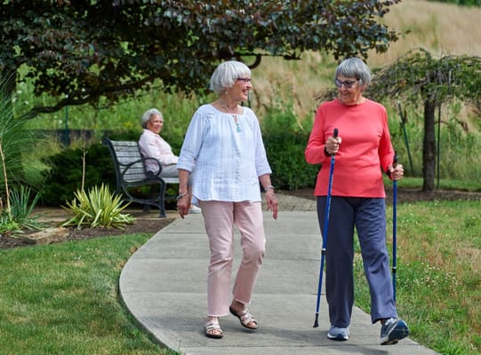 Two residents walking on a garden path