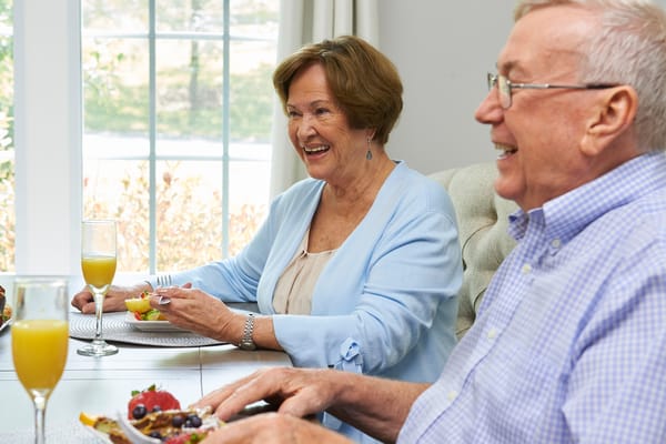 Residents enjoying a meal together at a dining table