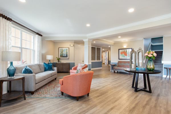 Common area with seating and decor in a senior living facility
