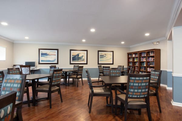 A common area with tables and chairs in the facility