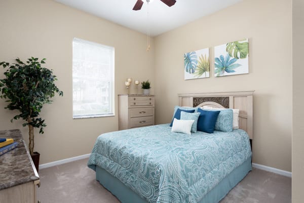 A beautifully decorated resident room with a bed and plants