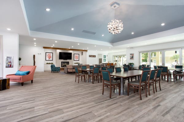 Bright dining area with tables and chairs for residents