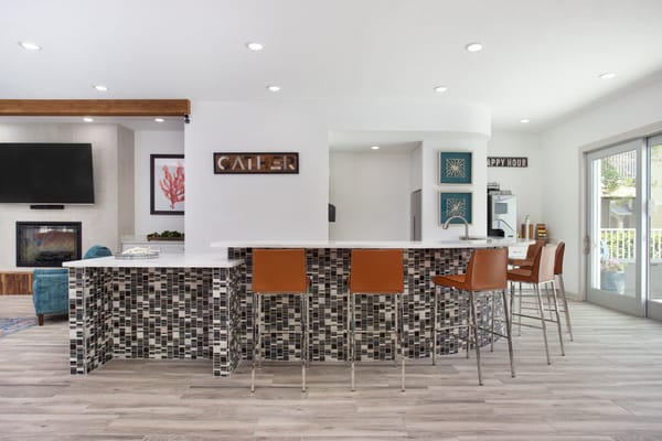 Bright common area with bar stools and modern decor