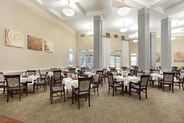 Dining area with neatly set tables and chairs