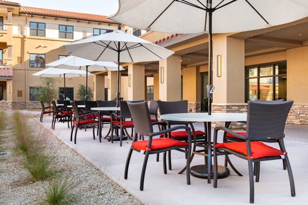 Outdoor seating area with umbrellas and tables.