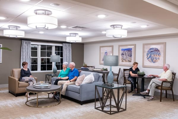Residents socializing in a common area lounge