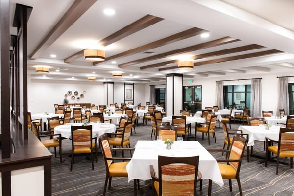 Dining area with tables and chairs set up for residents