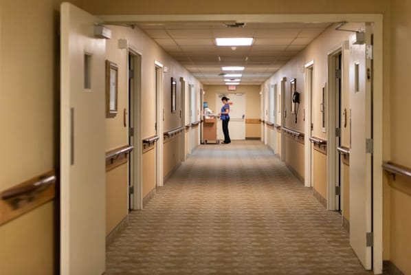 Corridor of a nursing facility with staff member