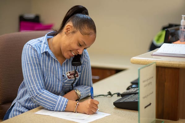 Staff member assisting at the reception desk
