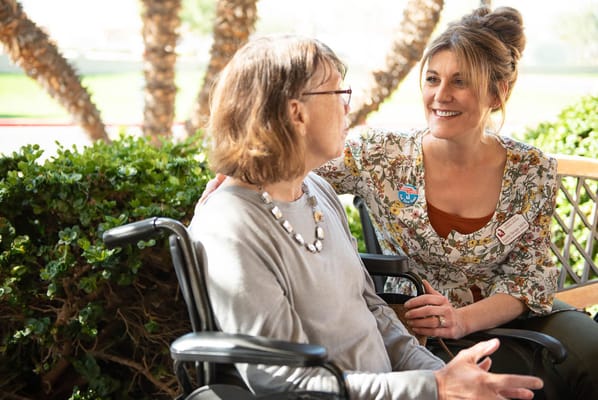 Staff member engaging with a resident outdoors