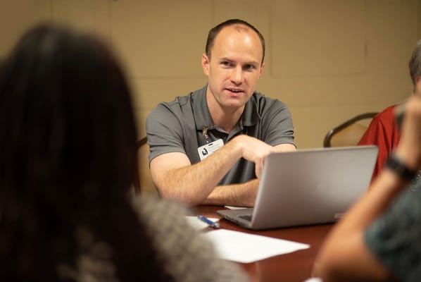 Staff member engaging with residents during a meeting