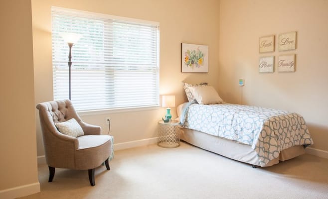 Cozy resident room with a bed and chair