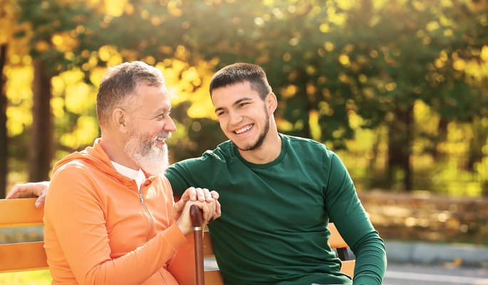 Two men enjoying time together in a sunny outdoor setting
