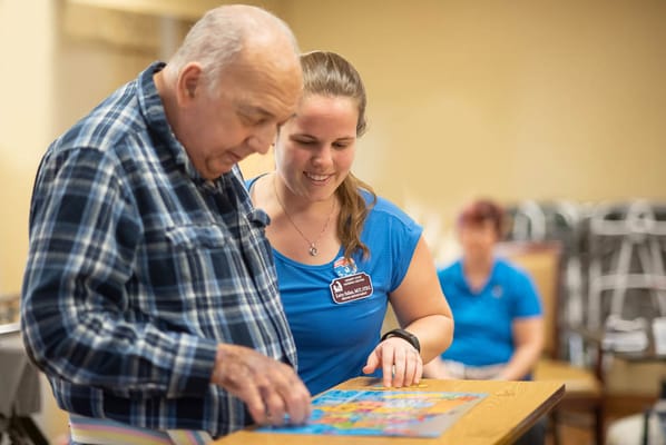 Resident and staff member engaging in a bingo activity