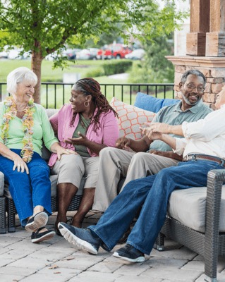 Residents chatting in an outdoor seating area