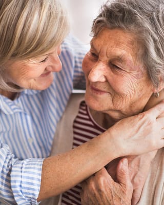 Caregiver embracing a senior resident with warmth