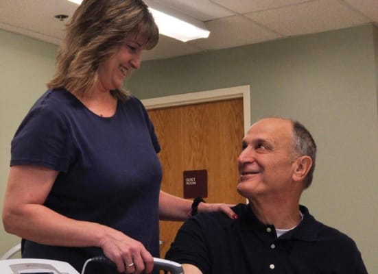 Nurse interacting with a resident in a facility room
