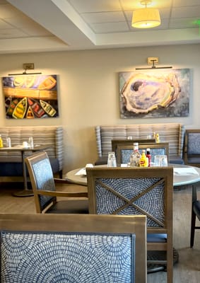 Dining room setup with tables and art on the walls