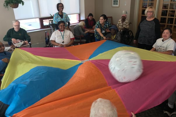 Residents and staff participating in a colorful group activity
