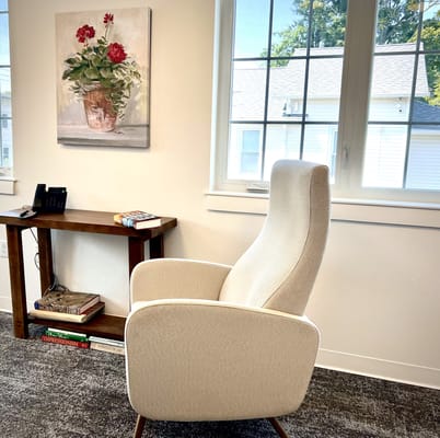 Cozy chair and a flower painting in a common area