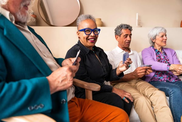 Residents enjoying a card game in a common area
