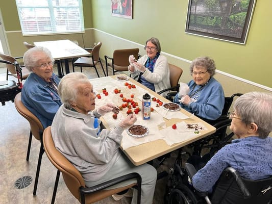 Residents enjoying an activity making chocolate-covered strawberries