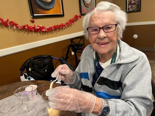 Resident enjoying a dessert activity in the dining area