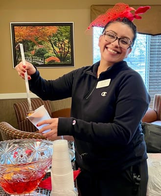 Staff member serving refreshments at a community event