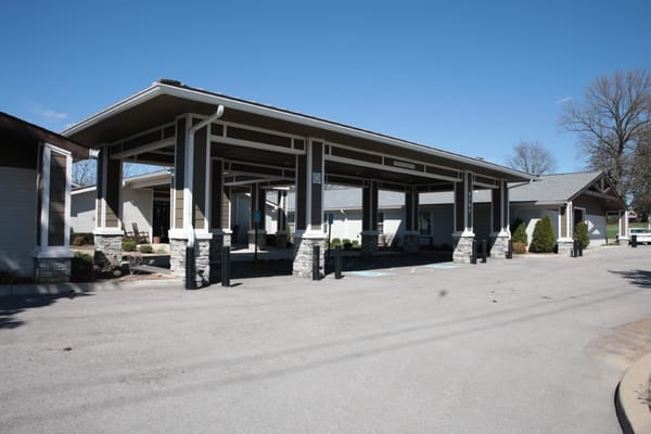 Covered entrance of a senior living facility with parking