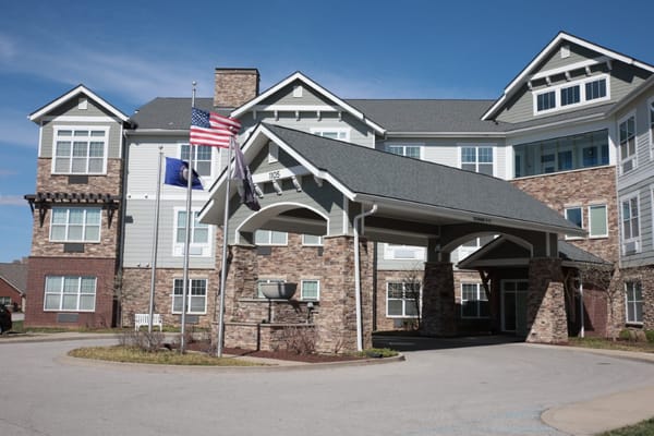 Exterior view of a senior living facility with flags